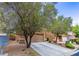 Two-story home with attached two-car garage, mature trees, and desert landscaping at 9629 Toy Soldier St, Las Vegas, NV 89178