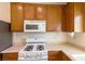 Kitchen features wood cabinets, white appliances and countertops at 9629 Toy Soldier St, Las Vegas, NV 89178