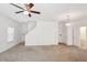 Spacious, bright living room with plush carpet, ceiling fan and chandelier at 9629 Toy Soldier St, Las Vegas, NV 89178