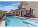 Outdoor oasis featuring a pool, seating area, and a covered patio at 9917 Fletcher Peak Ave, Las Vegas, NV 89178