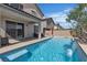 Backyard with a pool, covered patio, and landscaping at 9917 Fletcher Peak Ave, Las Vegas, NV 89178