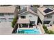 Backyard showcasing a refreshing pool, covered patio, and landscaped area for relaxation and entertaining at 9917 Fletcher Peak Ave, Las Vegas, NV 89178