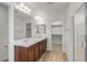 Bright bathroom featuring a double vanity, framed mirrors, and a walk-in closet at 9917 Fletcher Peak Ave, Las Vegas, NV 89178
