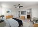 Virtual staging of a spacious bedroom with a ceiling fan and a view into the bathroom at 9917 Fletcher Peak Ave, Las Vegas, NV 89178
