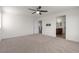 Spacious bedroom featuring a ceiling fan and a view into the bathroom at 9917 Fletcher Peak Ave, Las Vegas, NV 89178