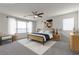 Virtual staging of a spacious bedroom with a ceiling fan and a view of the mountains at 9917 Fletcher Peak Ave, Las Vegas, NV 89178