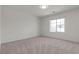 Bright bedroom with a large window, offering ample natural light and a neutral carpet at 9917 Fletcher Peak Ave, Las Vegas, NV 89178