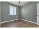 Relaxing bedroom features green-painted walls, neutral flooring, a window with blinds, and ample natural light at 9917 Fletcher Peak Ave, Las Vegas, NV 89178
