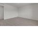 This spacious bedroom has neutral carpet and a doorway to another room at 9917 Fletcher Peak Ave, Las Vegas, NV 89178