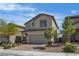 Charming two-story home with neutral stucco, tile roof, manicured landscaping, and brick paver driveway at 9917 Fletcher Peak Ave, Las Vegas, NV 89178