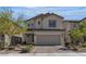 Beautiful home with a two-car garage, manicured landscaping, and a welcoming facade at 9917 Fletcher Peak Ave, Las Vegas, NV 89178