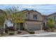 Charming two-story home with a well-maintained front yard and a brick driveway, showcasing curb appeal at 9917 Fletcher Peak Ave, Las Vegas, NV 89178
