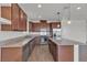 Modern kitchen featuring stainless steel appliances, a granite island, and dark wood cabinets at 9917 Fletcher Peak Ave, Las Vegas, NV 89178