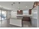 Contemporary kitchen features stainless steel appliances, granite countertops, island, pantry, and backyard view at 9917 Fletcher Peak Ave, Las Vegas, NV 89178