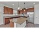 Modern kitchen featuring granite countertops, stainless steel appliances, and stylish pendant lighting over the island at 9917 Fletcher Peak Ave, Las Vegas, NV 89178