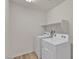 Laundry room featuring white washer and dryer, shelf and wood look flooring at 9917 Fletcher Peak Ave, Las Vegas, NV 89178