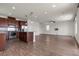 Open-concept living and kitchen area featuring hardwood floors, recessed lighting, and a breakfast bar at 9917 Fletcher Peak Ave, Las Vegas, NV 89178