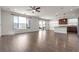 Bright, open-concept living area with hardwood floors, recessed lighting, and sliding glass doors to the backyard at 9917 Fletcher Peak Ave, Las Vegas, NV 89178