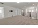 Spacious loft with carpeted flooring, neutral walls, modern railing, and access to multiple rooms at 9917 Fletcher Peak Ave, Las Vegas, NV 89178