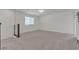 Open loft area with carpeted flooring, neutral walls, and a window, offering versatile space for entertainment at 9917 Fletcher Peak Ave, Las Vegas, NV 89178
