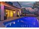 Inviting backyard pool area with string lights and a covered patio, great for outdoor relaxation and entertaining at 9917 Fletcher Peak Ave, Las Vegas, NV 89178