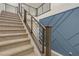 Carpeted staircase with a modern railing leading to the second floor of the home at 9917 Fletcher Peak Ave, Las Vegas, NV 89178