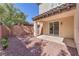 The covered patio provides a cool spot to relax and enjoy the low-maintenance backyard at 10345 Howling Coyote Ave, Las Vegas, NV 89135