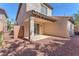 This private backyard features a covered patio area and easy-care desert landscaping at 10345 Howling Coyote Ave, Las Vegas, NV 89135