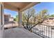 Enjoy outdoor living on this covered balcony with wrought iron railing overlooking a lush landscape at 10345 Howling Coyote Ave, Las Vegas, NV 89135