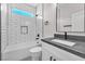 Well-lit bathroom with subway tile, a shower-tub combo, and a sleek vanity at 10345 Howling Coyote Ave, Las Vegas, NV 89135