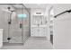 Bright bathroom with a glass-enclosed shower and a view of an open shelving unit at 10345 Howling Coyote Ave, Las Vegas, NV 89135