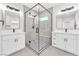 Modern bathroom featuring a glass shower, dual sinks, and neutral color palette at 10345 Howling Coyote Ave, Las Vegas, NV 89135