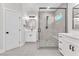 A bathroom featuring a frameless shower with mosaic tile and double vanity at 10345 Howling Coyote Ave, Las Vegas, NV 89135