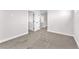 A bedroom featuring carpet floors, a white baseboard, and access to a hallway at 10345 Howling Coyote Ave, Las Vegas, NV 89135