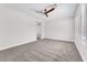 Large bedroom featuring neutral carpet, a ceiling fan, and natural light at 10345 Howling Coyote Ave, Las Vegas, NV 89135