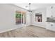 Bright dining area features sliding glass doors and modern light fixture at 10345 Howling Coyote Ave, Las Vegas, NV 89135