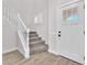 Inviting entryway features a staircase and a front door with glass panes at 10345 Howling Coyote Ave, Las Vegas, NV 89135