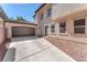 Attached two-car garage and driveway complemented by tasteful desert landscaping and an inviting entrance at 10345 Howling Coyote Ave, Las Vegas, NV 89135