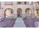 Charming home featuring an arched entryway, covered porch, and well-maintained landscaping at 10345 Howling Coyote Ave, Las Vegas, NV 89135