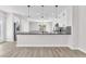 Modern kitchen with white cabinets, dark countertops, and stainless steel appliances at 10345 Howling Coyote Ave, Las Vegas, NV 89135