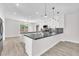 Spacious kitchen featuring white cabinets, dark countertops, stainless appliances and wood-look floors at 10345 Howling Coyote Ave, Las Vegas, NV 89135