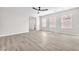 Bright living room with light wood flooring and multiple windows at 10345 Howling Coyote Ave, Las Vegas, NV 89135