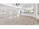 Bright, open-concept living area with wood-look floors, and access to kitchen at 10345 Howling Coyote Ave, Las Vegas, NV 89135