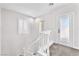 Carpeted staircase featuring a white railing and a window with shutters at 10345 Howling Coyote Ave, Las Vegas, NV 89135