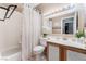 A serene bathroom with a shower-tub combination, vanity, and ample lighting at 10701 Windrose Point Ave, Las Vegas, NV 89144