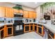 Bright kitchen area featuring light wood cabinets, tile backsplash, and modern appliances at 10701 Windrose Point Ave, Las Vegas, NV 89144