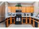 Well-lit kitchen featuring wooden cabinets, stainless steel appliances, and tile countertops at 10701 Windrose Point Ave, Las Vegas, NV 89144