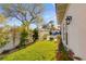 Well-maintained backyard with green lawn, white fence, and mature trees, creating a private oasis at 10717 Beringer Dr, Las Vegas, NV 89144
