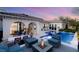 Expansive backyard featuring a pool, spa, fire pit, and ample seating areas at 10717 Beringer Dr, Las Vegas, NV 89144