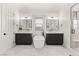 Sleek bathroom with modern fixtures, standalone tub, and and sink vanities at 10717 Beringer Dr, Las Vegas, NV 89144